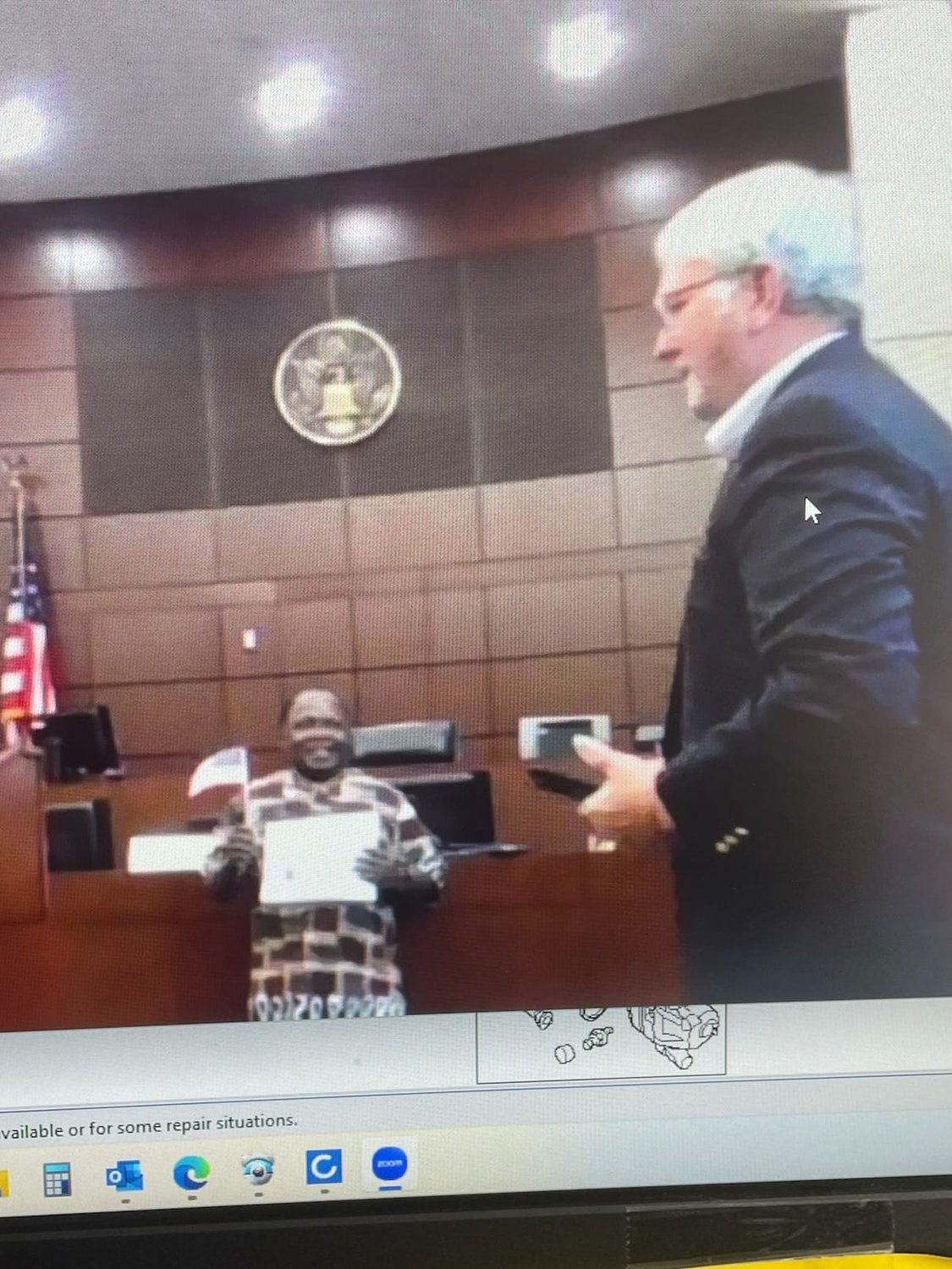 This is a screen shot of the livestream of Father Boniface Kasiita Nzabonimpa as he takes his pledge in St. Louis in order to become a U.S. citizen.